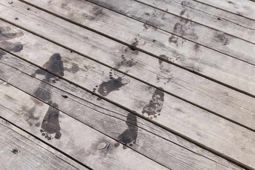 Wet footprints on a pier. photo