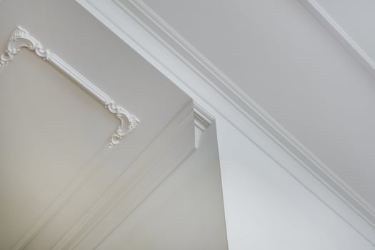 corner of ceiling and walls with intricate crown moulding. Interior construction and renovation concept. photo