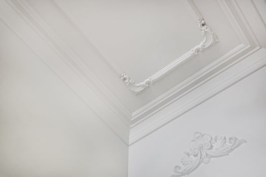 Detail of corner ceiling cornice with intricate crown molding. photo