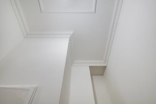 Detail of corner ceiling cornice with intricate crown molding. photo