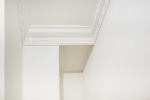 Detail of corner and ceiling cornice with intricate crown molding. photo