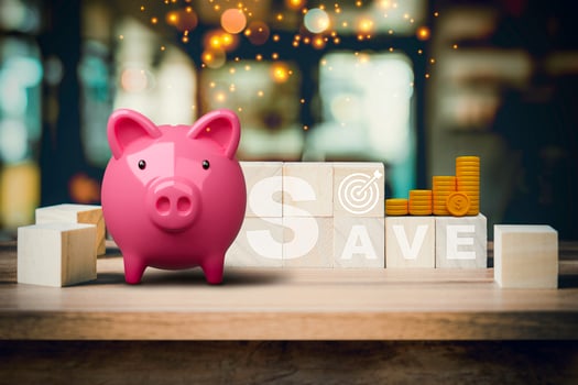 Pink piggy bank with SAVE words on wooden cube in abstract bokeh interior cafe backdrop. Business finance concept of planning, saving money wealth, financial and investment. photo