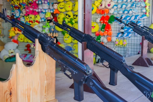 shooting gallery at the fair. Black rifles  for target shooting photo