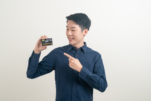 young Asian man holding credit card photo