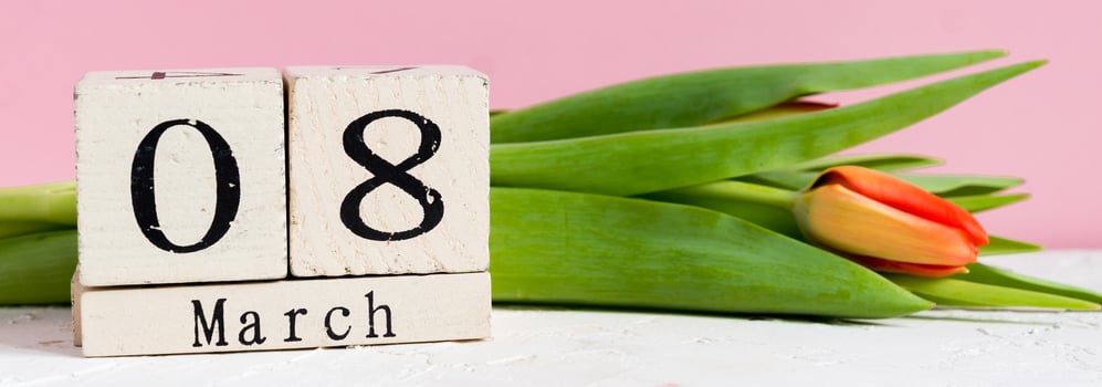 Intarnational women day. Wooden calendar 8 of march and red tulips on pink background, banner photo