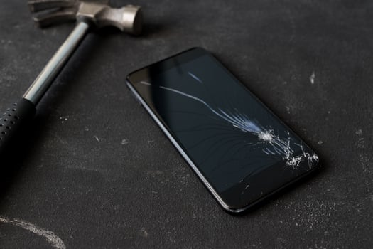 Cracked mobile smartphone smashed by a hummer. photo