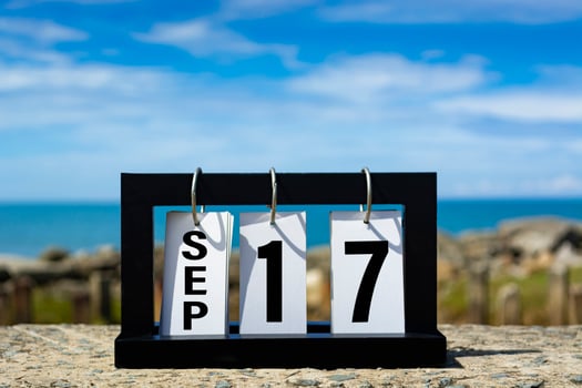 Sep 17 calendar date text on wooden frame with blurred background of ocean. photo