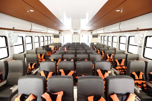 Many Seats row inside luxury cruise ferry with orange life vest jackets for Tourist to use to swim in Ocean sea and snorkeling underwater trip and safety first during transport photo