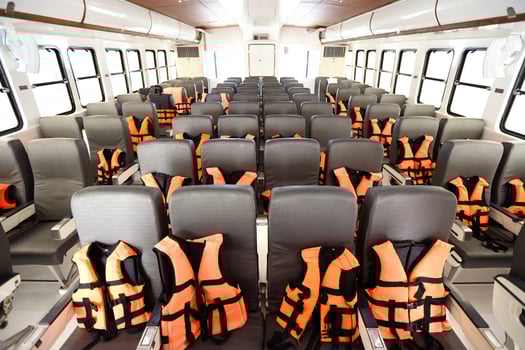 Many Seats row inside luxury cruise ferry with orange life vest jackets for Tourist to use to swim in Ocean sea and snorkeling underwater trip and safety first during transport photo