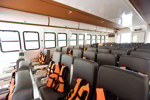 Many Seats row inside luxury cruise ferry with orange life vest jackets for Tourist to use to swim in Ocean sea and snorkeling underwater trip and safety first during transport photo