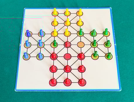 gameplay of solitaire board game on green table photo