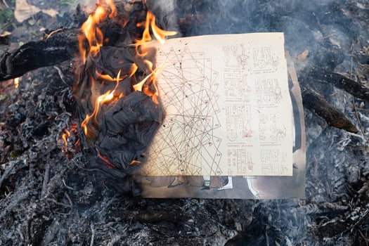 vintage cutting patterns buring in old bonfire photo