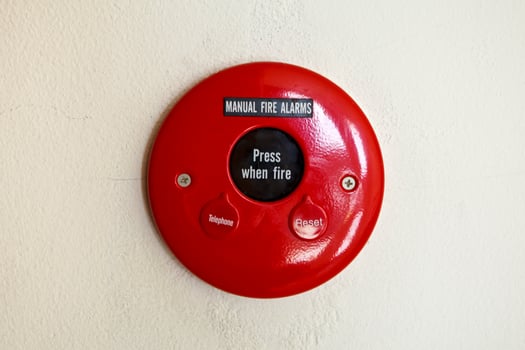 Red fire alarm on wall photo