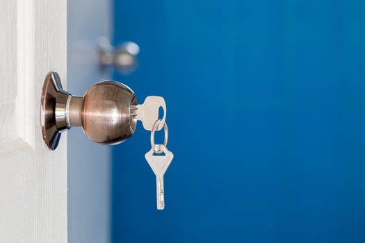 Open door with keys, key in keyhole photo