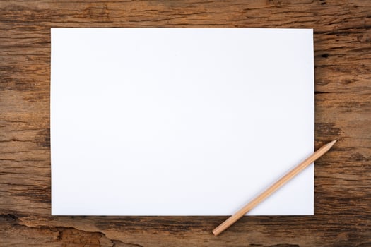 White paper with  pencil on wooden table photo