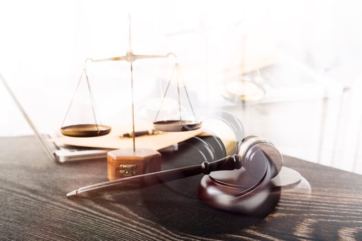Business and lawyers discussing contract papers with brass scale on desk in office. Law, legal services, advice, justice and law concept picture with film grain effect photo