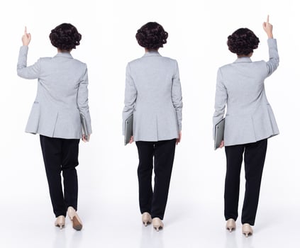 Full length 30s 40s Asian Woman teacher manager business, pointing finger up in Air, wear formal blazer pants shoes. Smile Office female carry laptop coffee cup over white background isolated photo
