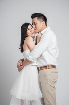 Happy young Asian couple in love embracing photo