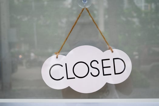 Closed label on the cloud-shaped board, hanging behind the glass door at coffee shop. photo