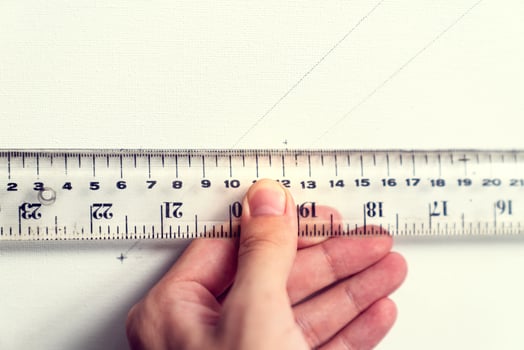 hand holding ruler with canvas background photo