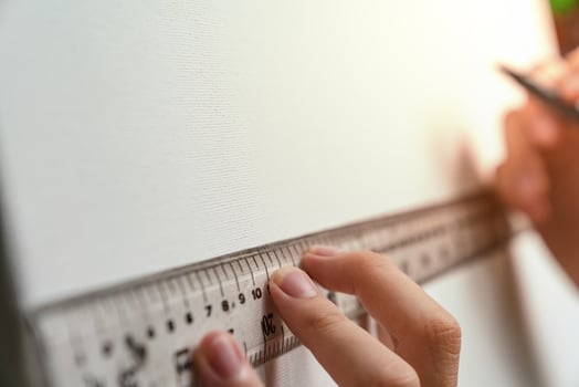 hand holding ruler and clutch-type pencil with canvas background photo