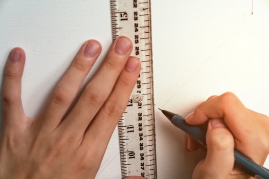 hand holding ruler and clutch-type pencil with canvas background photo