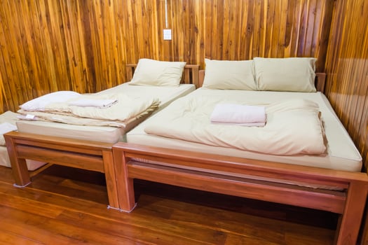 wooden bed in a wood house photo