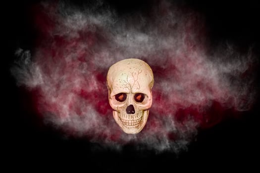 skull with red and black smoke on black background photo