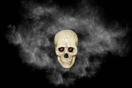 skull with white smoke on black background photo