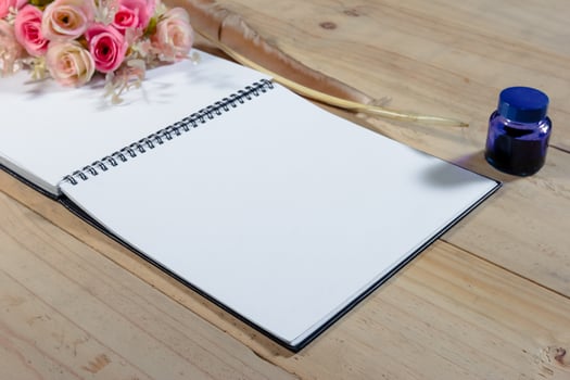 open note book with feather pen,filter effect. photo