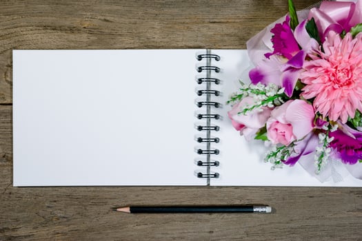 open note book with pencil on wood background photo