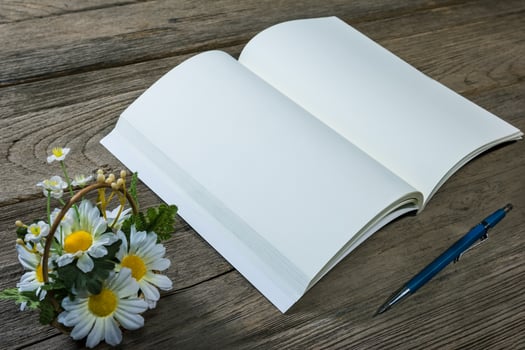 open note book with clutch-type pencil on wood background photo