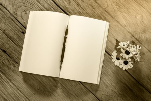 open note book with clutch-type pencil on wood background,,filter effect. photo