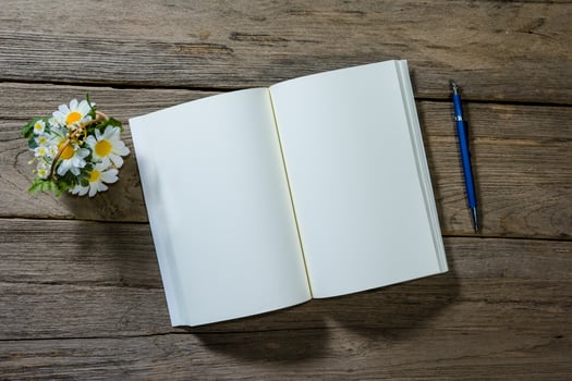 open note book with clutch-type pencil on wood background photo