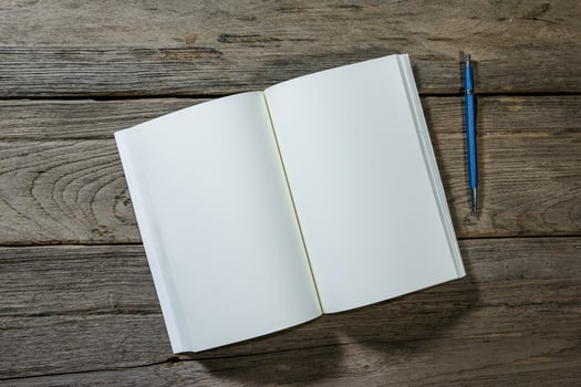 open note book with clutch-type pencil on wood background,,filter effect. photo