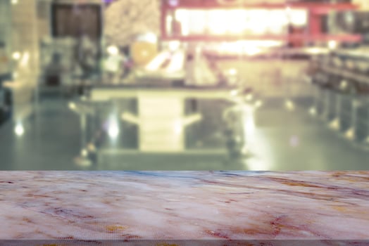 Marble table with restaurant blur background photo
