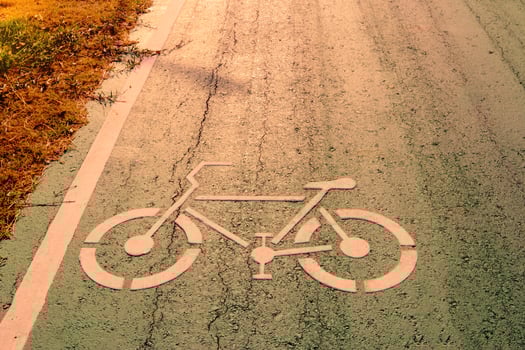 Bicycle symbol on city street with morning sunlight photo