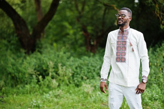 Portrait of african man in traditional clothes at park. photo