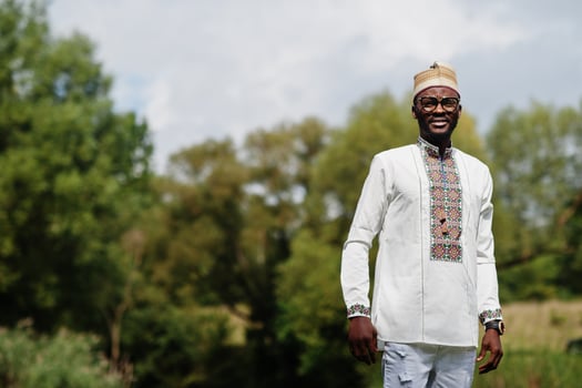 Portrait of african man in traditional clothes at park. photo