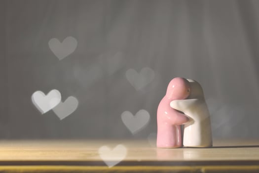 Clay dolls are hugging each other in love. Concept of love, care and nostalgia photo