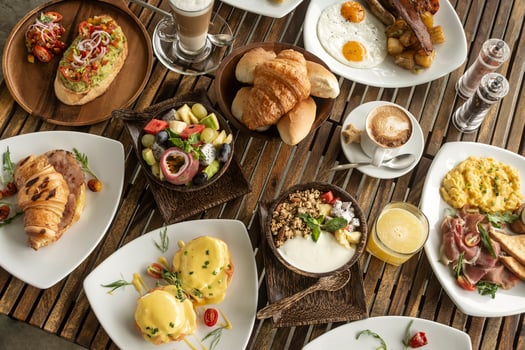 many mixed western breakfast food items on cafe table photo