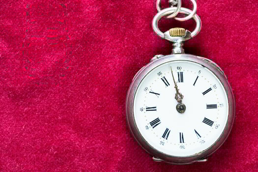 retro pocket watch on red velvet background photo