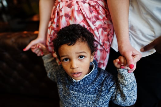 Happy multiethnic family with boy kid spend time at restaurant. Relationships of african man and white european woman. photo