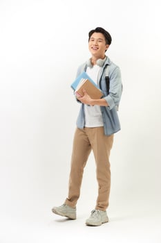Young happy student carrying books photo