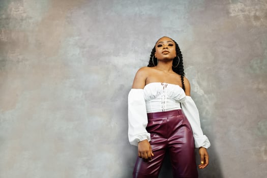 Beautiful african american woman in white blouse and red leather pants pose at restaurant. photo