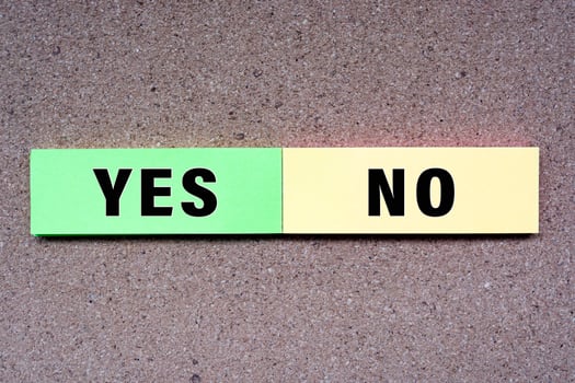 Yes No written on note with wooden background. Approved and Declined concept. photo
