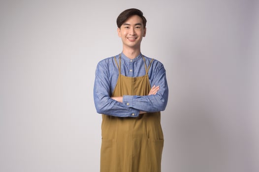 Portrait of young asian man wearing apron over white background studio, cooking and entrepreneur concept photo