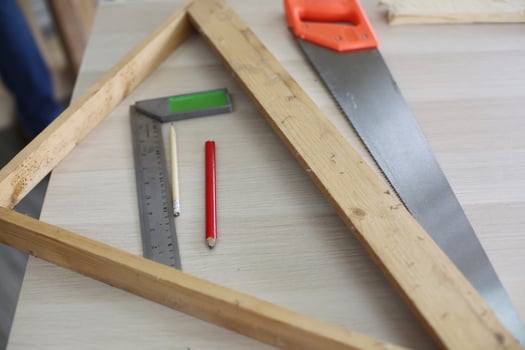 Carpenter grinding joinery product with carvings, finishing woodwork at the carpentry manufacturing photo