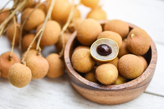 Dimocarpus longan exotic fruits on wooden bowl background - Fresh Longan  tropical fruit in Thailand photo
