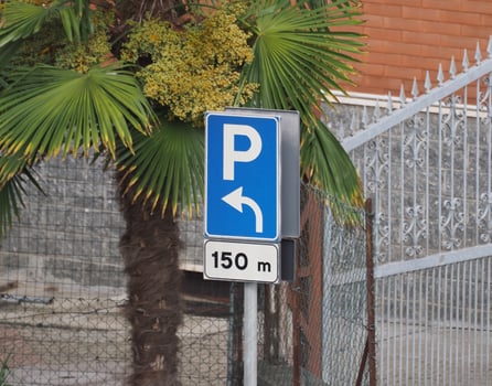 parking sign with direction arrow photo